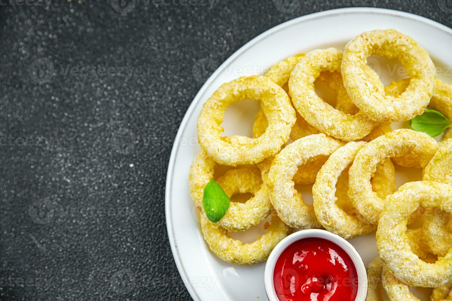 onion rings deep fryer tomato sauce fast food eating cooking meal food snack on the table copy space food background rustic top view photo