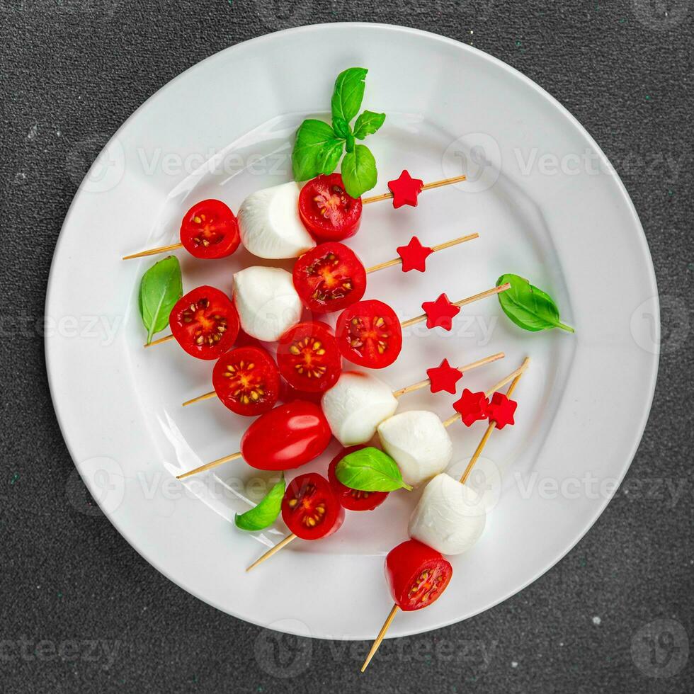 tomato and mozzarella salad on a skewer Caprese finger food appetizer eating cooking appetizer meal food snack on the table photo