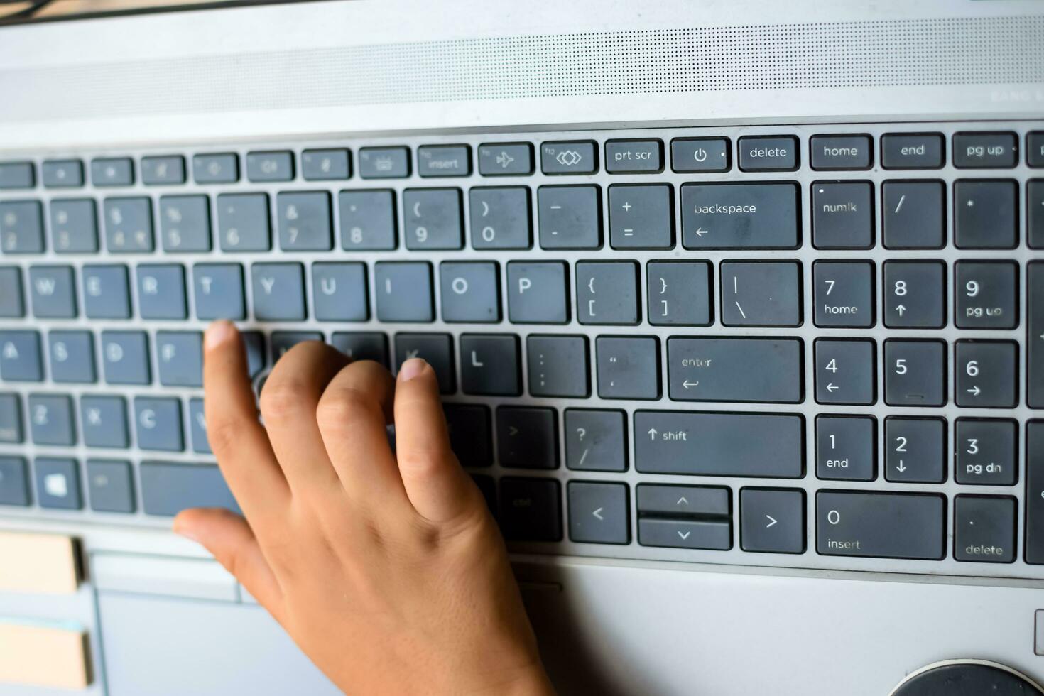 Little boy sitting at table using laptop for online class in Grade 1, Child studying on laptop from home for distance learning online education, School boy children lifestyle concept photo