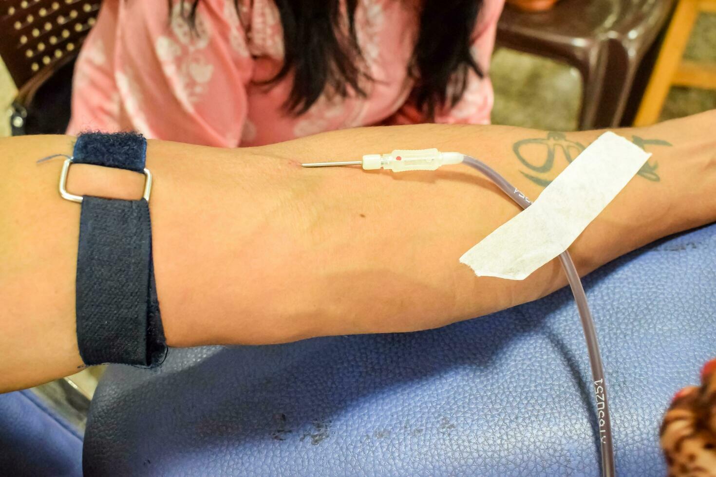 Blood donor at Blood donation camp held with a bouncy ball holding in hand at Balaji Temple, Vivek Vihar, Delhi, India, Image for World blood donor day on June 14 every year, Blood Donation Camp photo