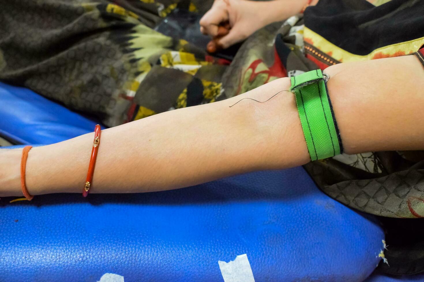 Blood donor at Blood donation camp held with a bouncy ball holding in hand at Balaji Temple, Vivek Vihar, Delhi, India, Image for World blood donor day on June 14 every year, Blood Donation Camp photo