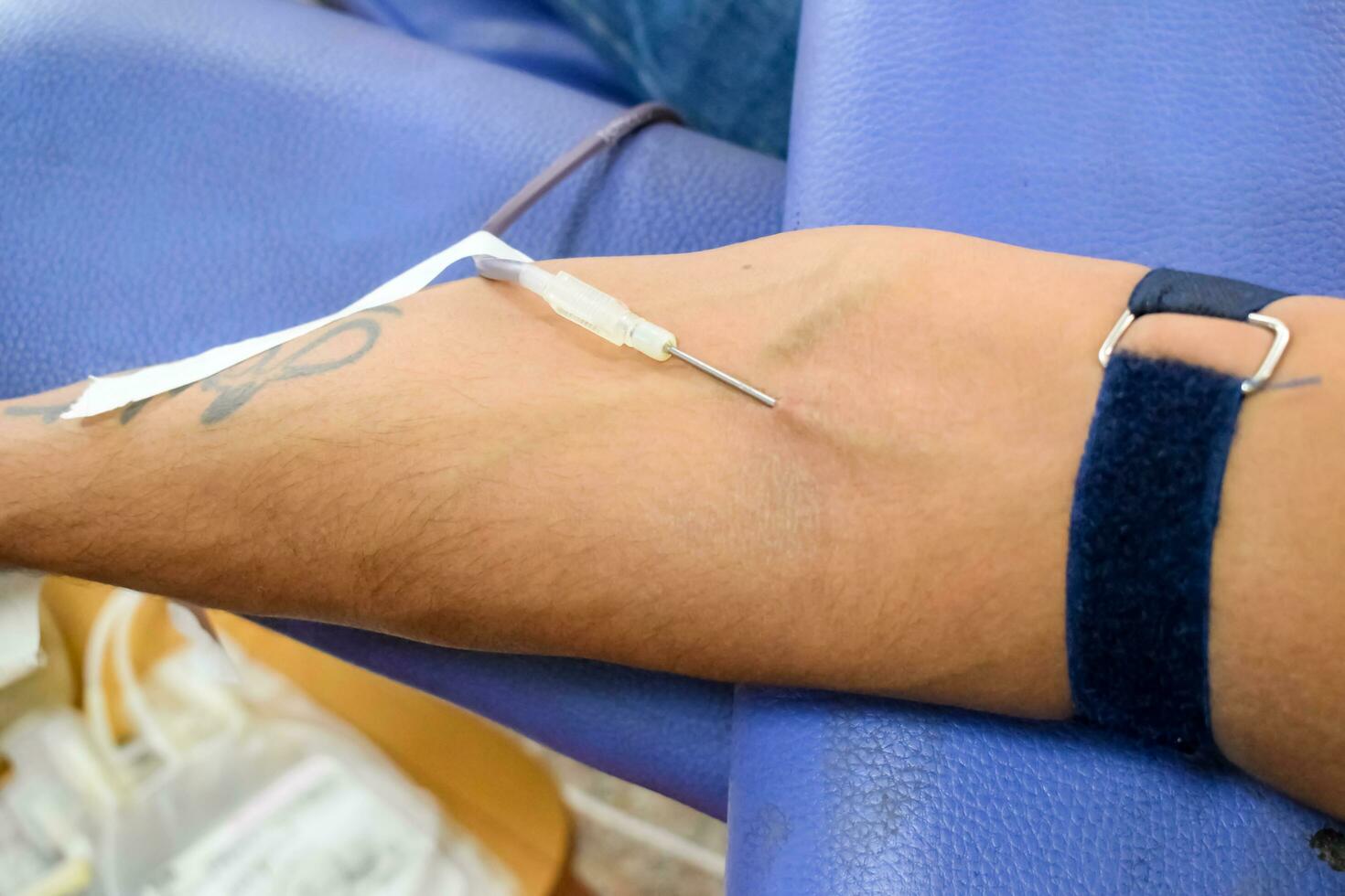 Blood donor at Blood donation camp held with a bouncy ball holding in hand at Balaji Temple, Vivek Vihar, Delhi, India, Image for World blood donor day on June 14 every year, Blood Donation Camp photo