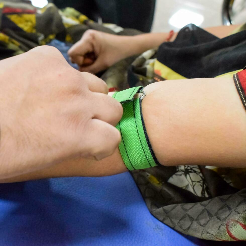 Blood donor at Blood donation camp held with a bouncy ball holding in hand at Balaji Temple, Vivek Vihar, Delhi, India, Image for World blood donor day on June 14 every year, Blood Donation Camp photo