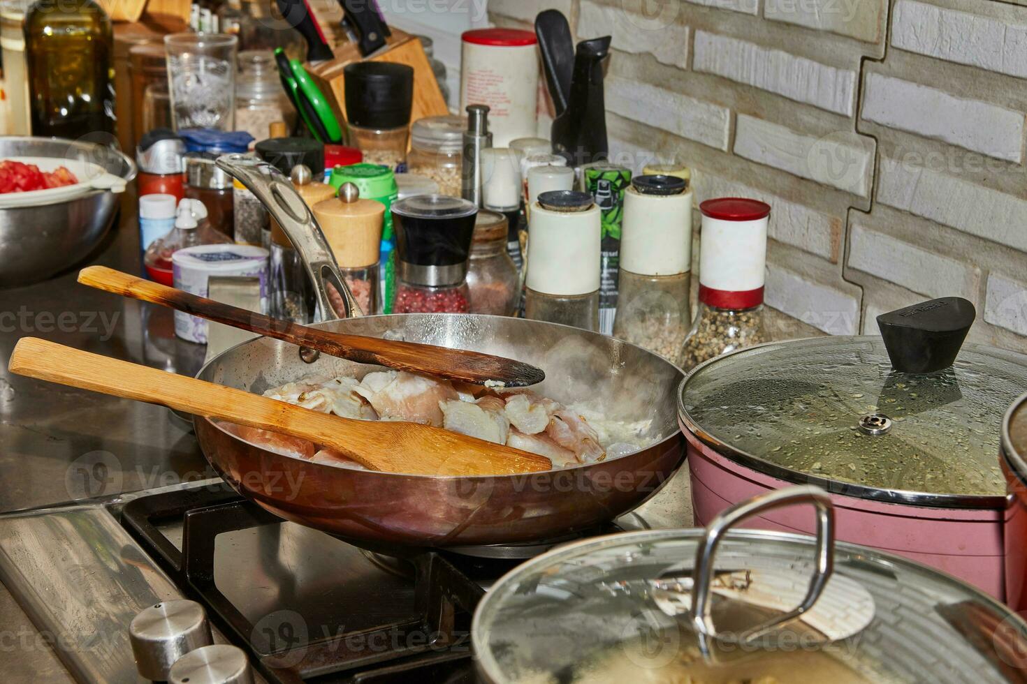 Pots with cooking food in the kitchen on gas stove photo