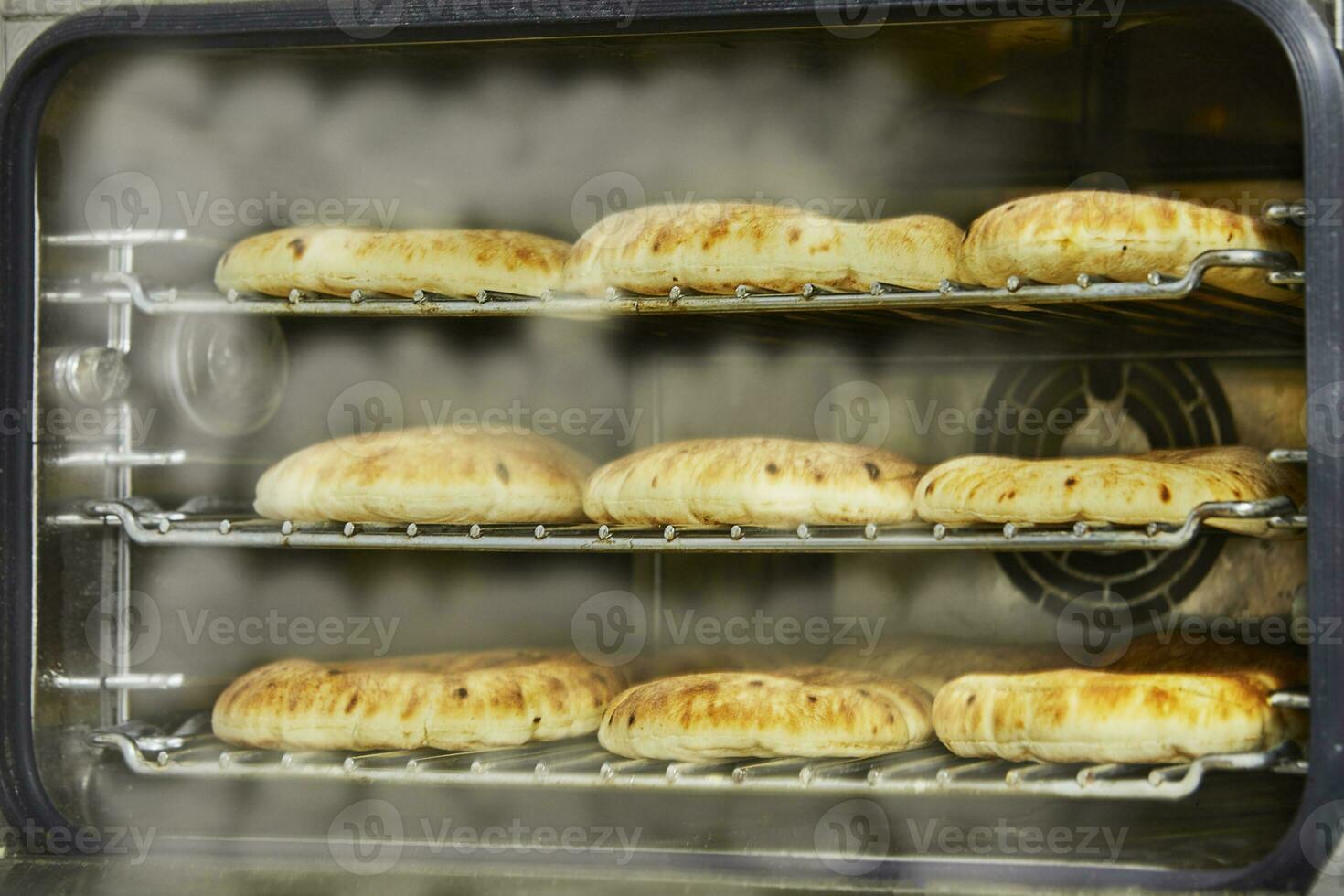 Pitas in the oven with steam, after baking in an electric oven photo