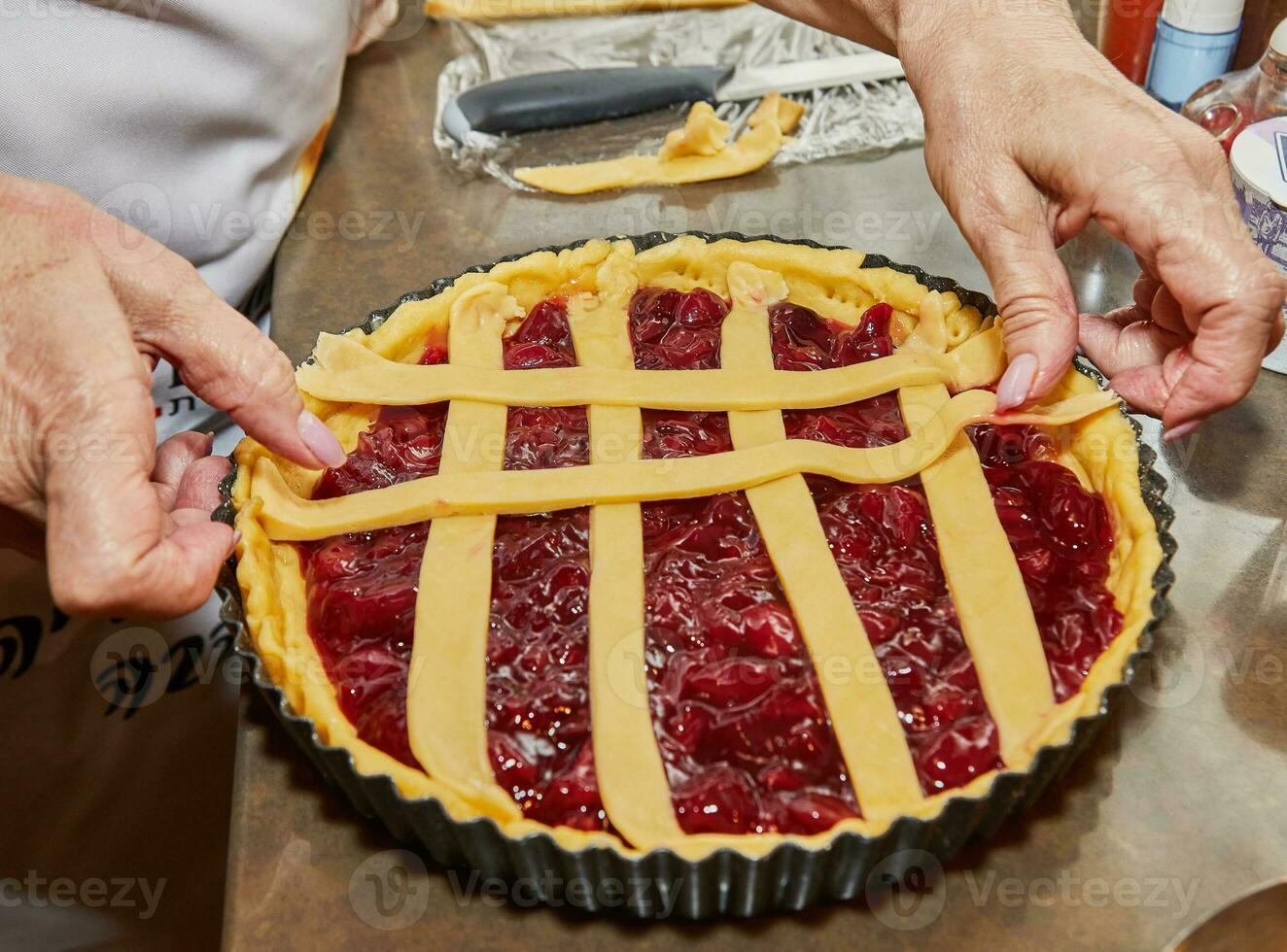 Chef makes cherry pie in his home kitchen photo