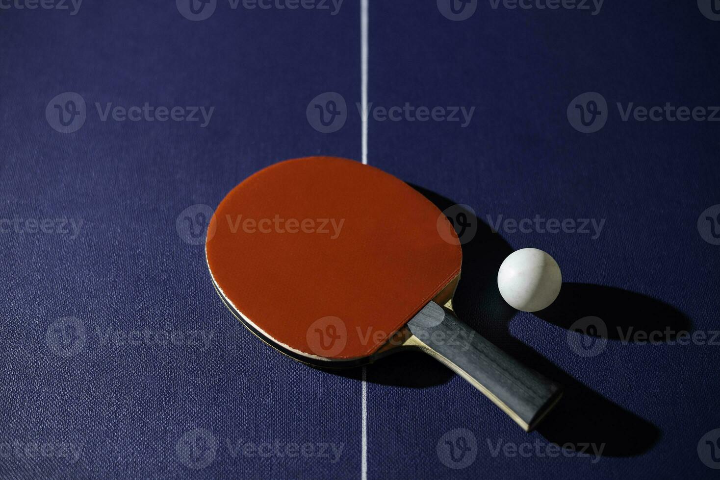 table tennis racket On the blue ping pong table photo