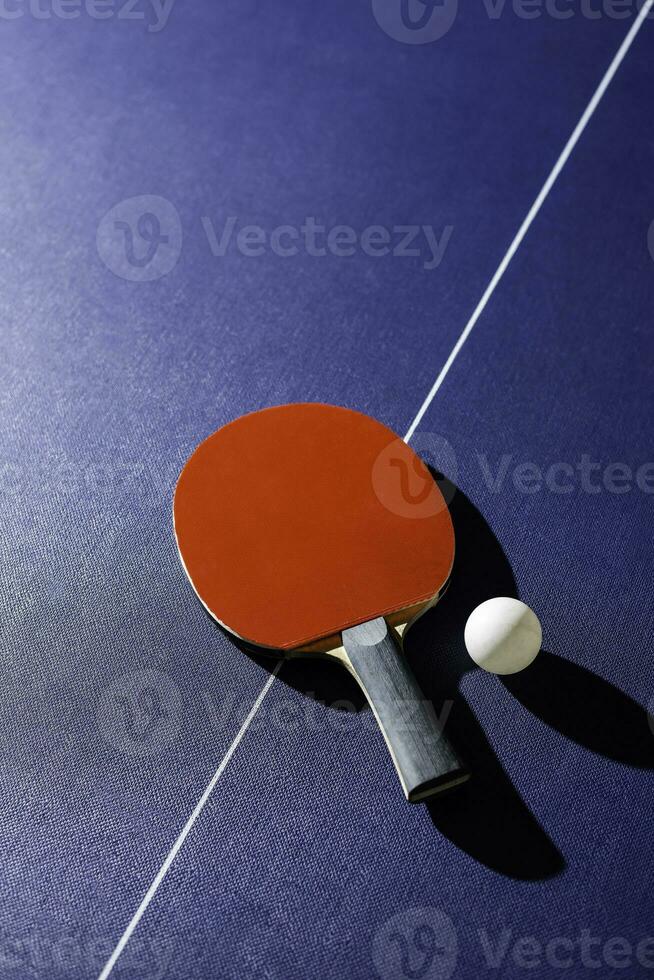 table tennis racket On the blue ping pong table photo