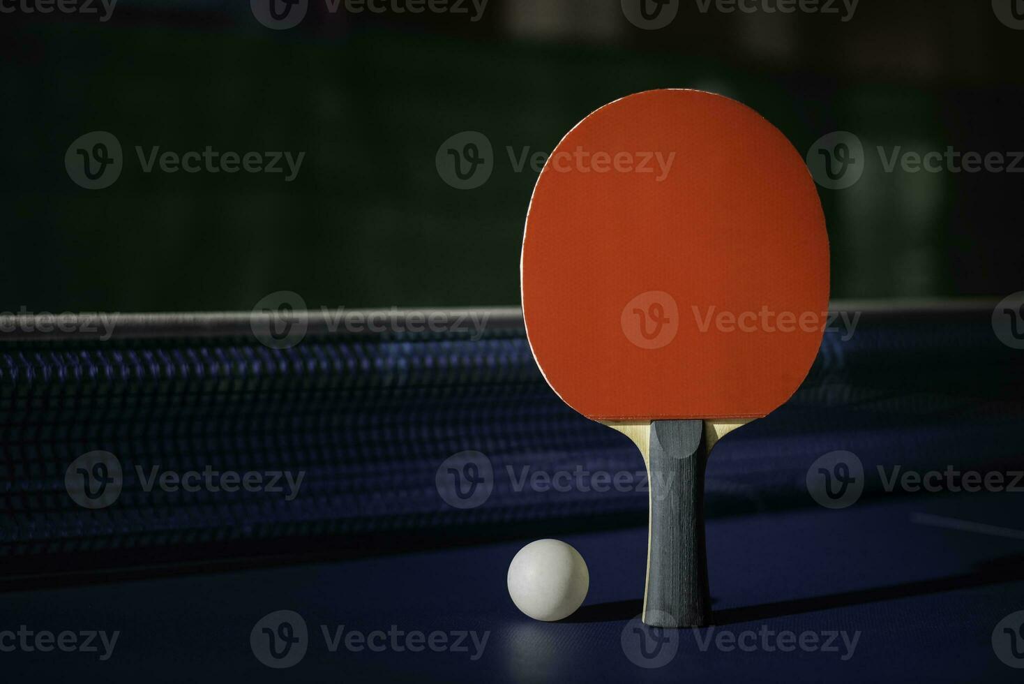 table tennis racket On the blue ping pong table photo