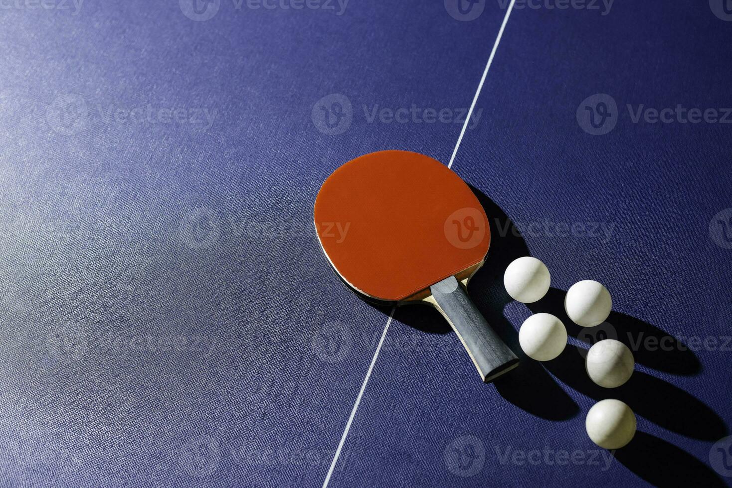 table tennis racket On the blue ping pong table photo