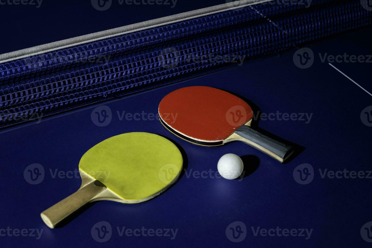 table tennis racket On the blue ping pong table photo