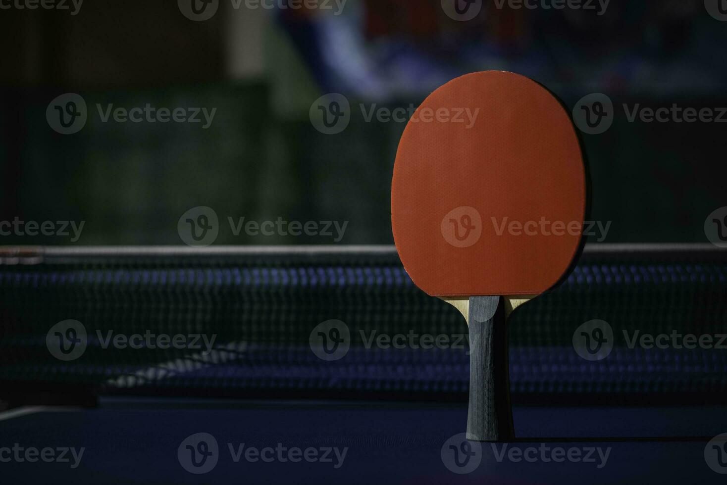 table tennis racket On the blue ping pong table photo