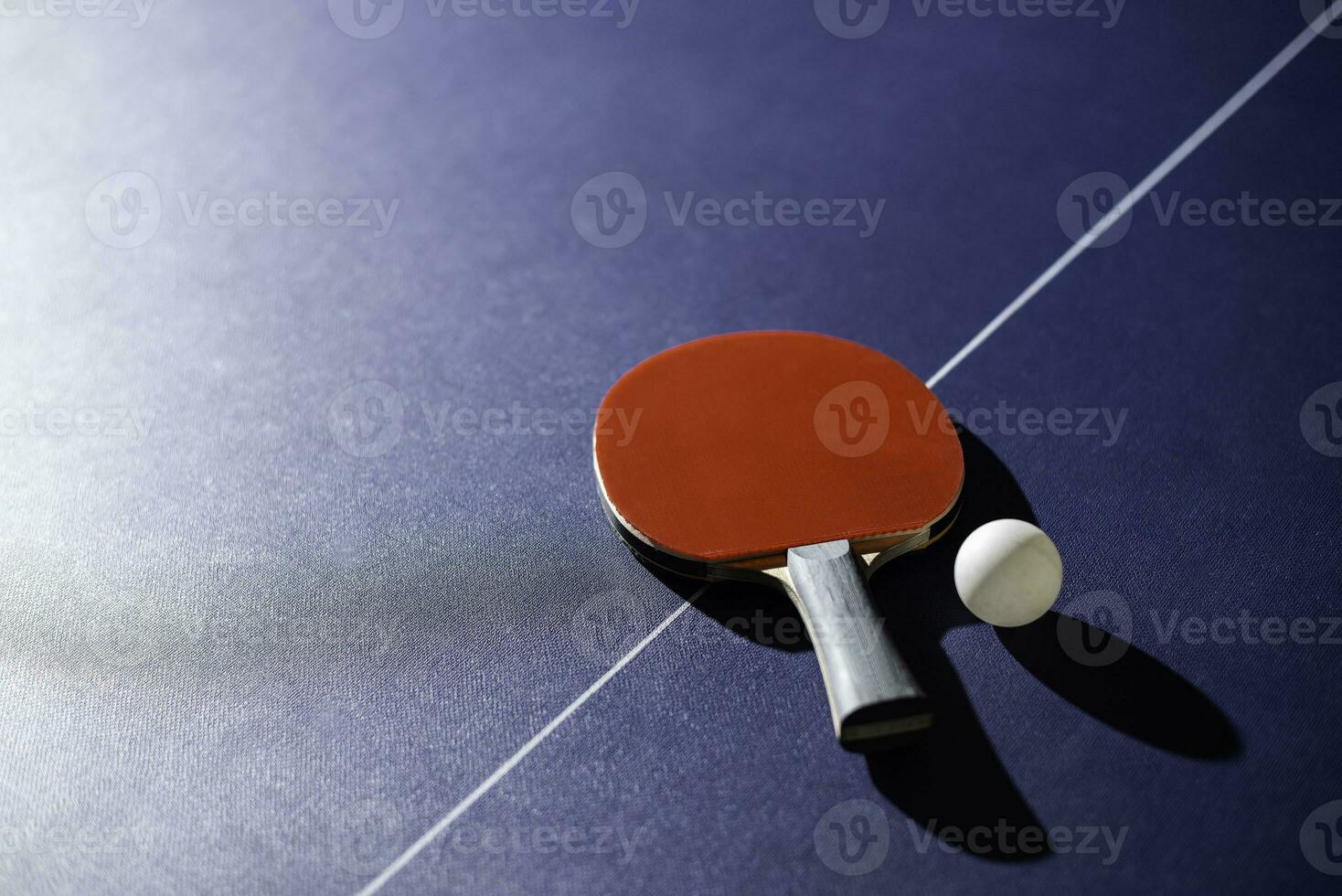 table tennis racket On the blue ping pong table photo