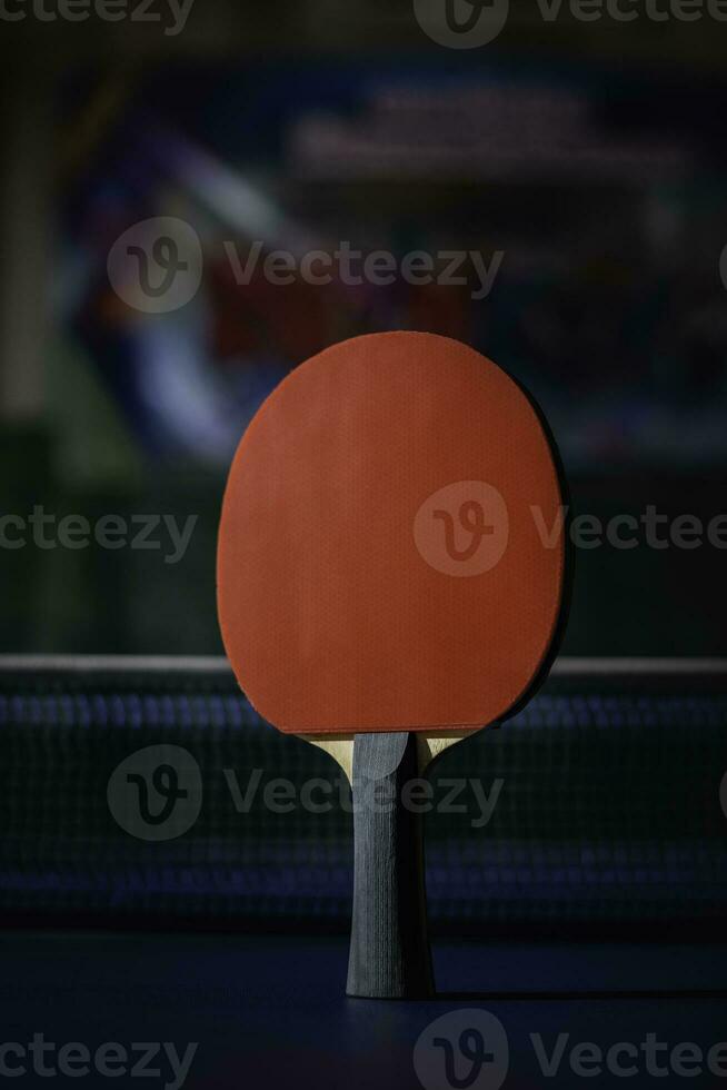 table tennis racket On the blue ping pong table photo