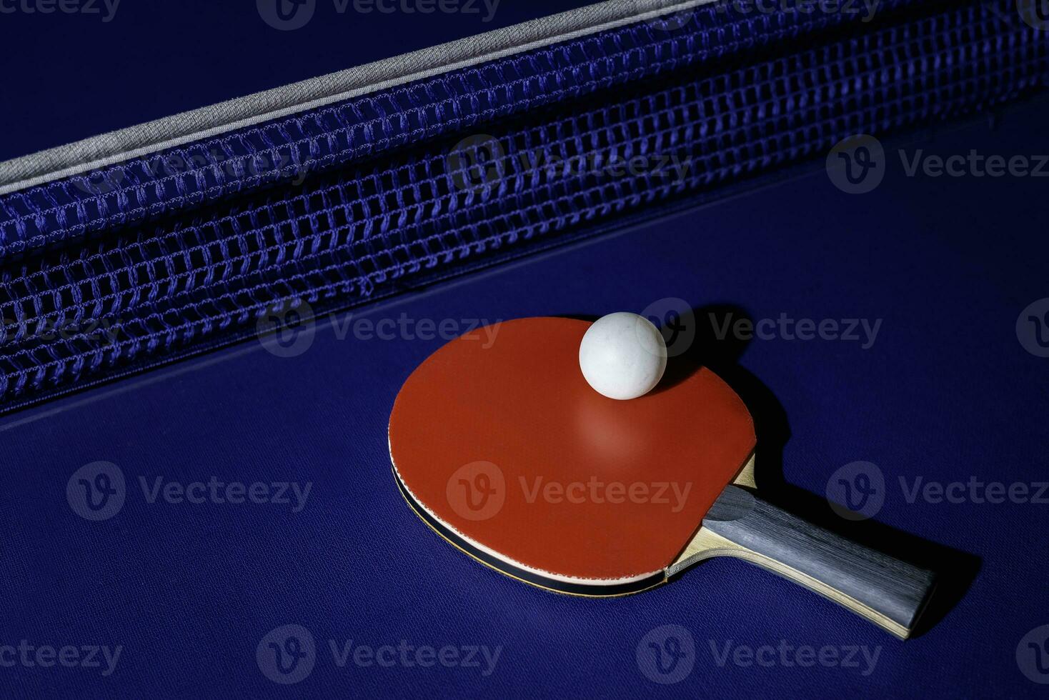 table tennis racket On the blue ping pong table photo