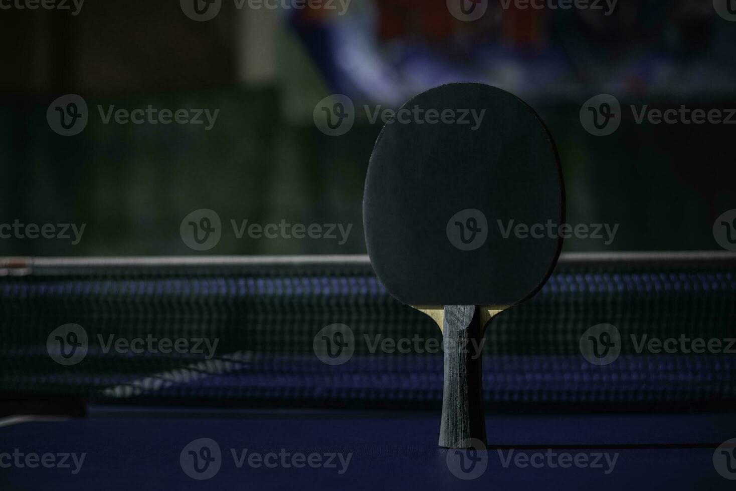 table tennis racket On the blue ping pong table photo