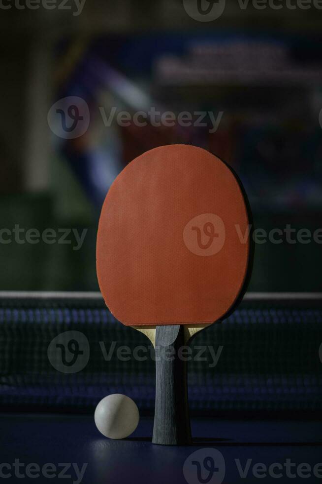 table tennis racket On the blue ping pong table photo