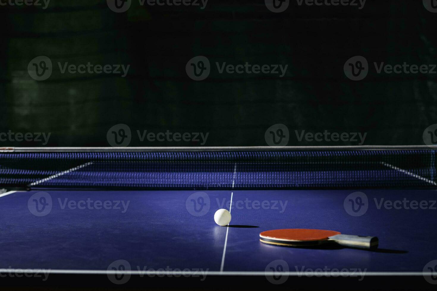 table tennis racket On the blue ping pong table photo