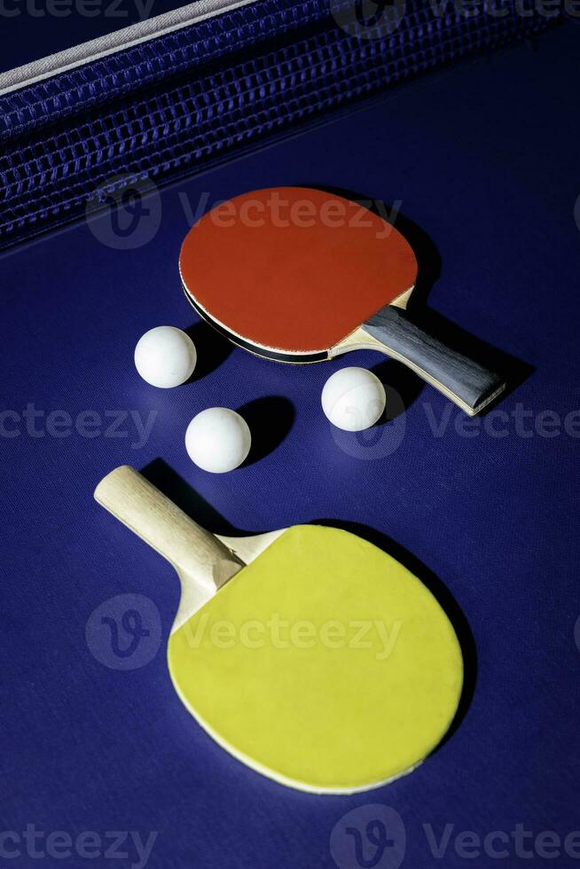 table tennis racket On the blue ping pong table photo