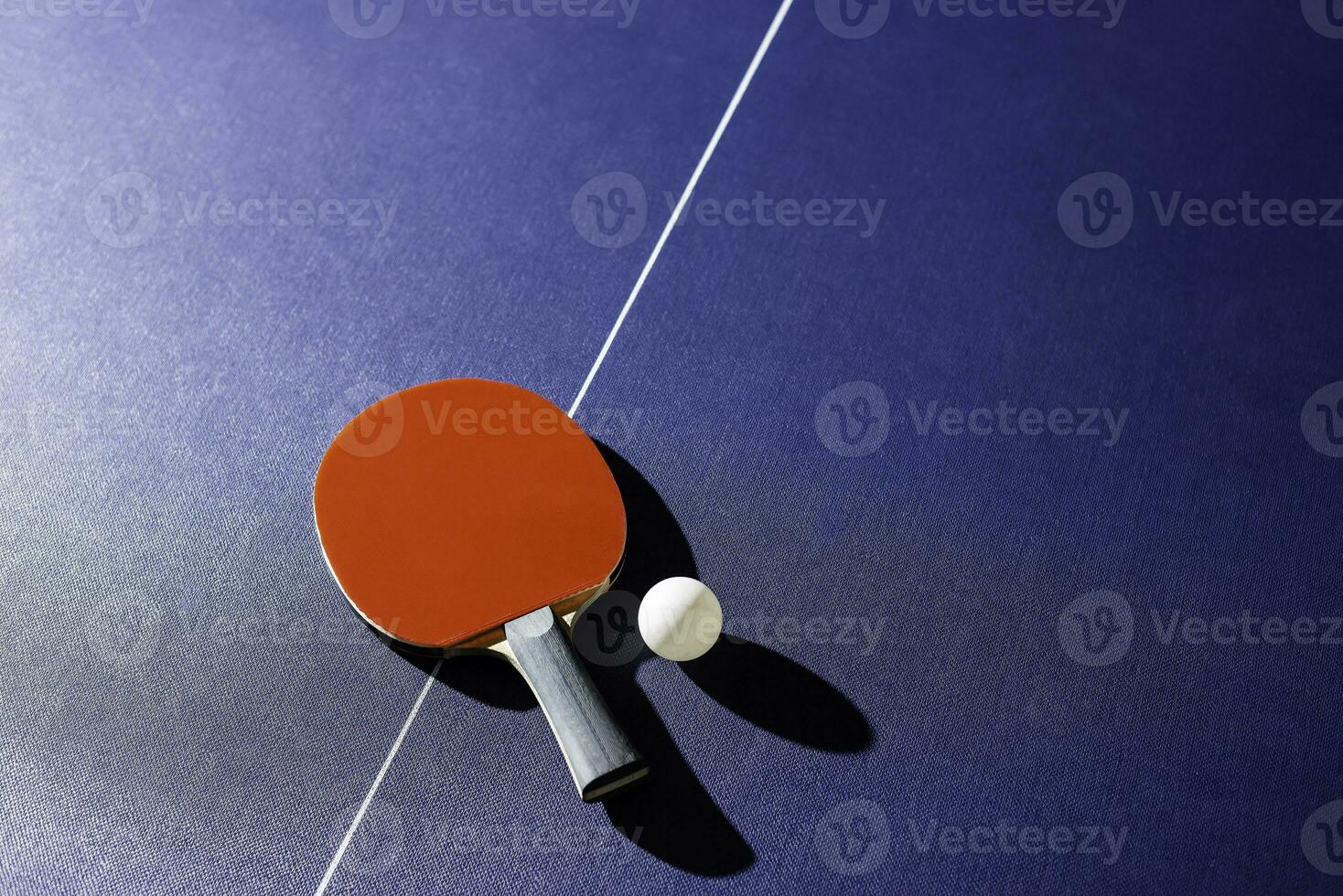 table tennis racket On the blue ping pong table photo