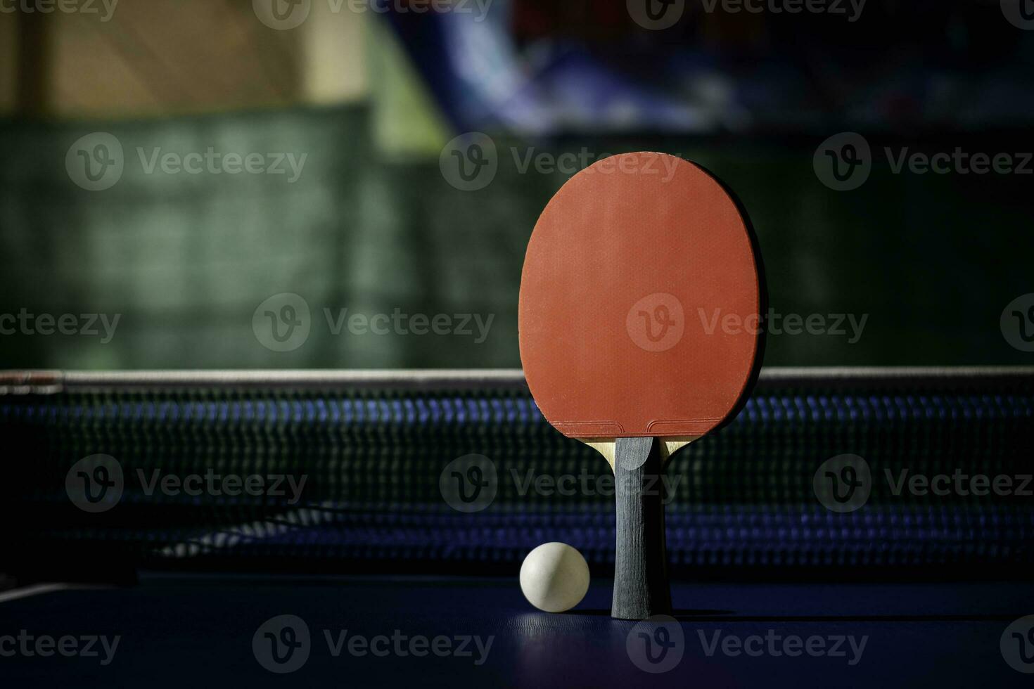 table tennis racket On the blue ping pong table photo