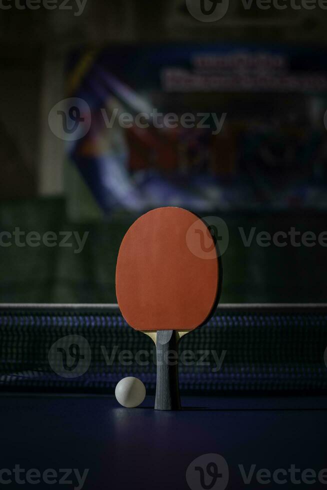 table tennis racket On the blue ping pong table photo