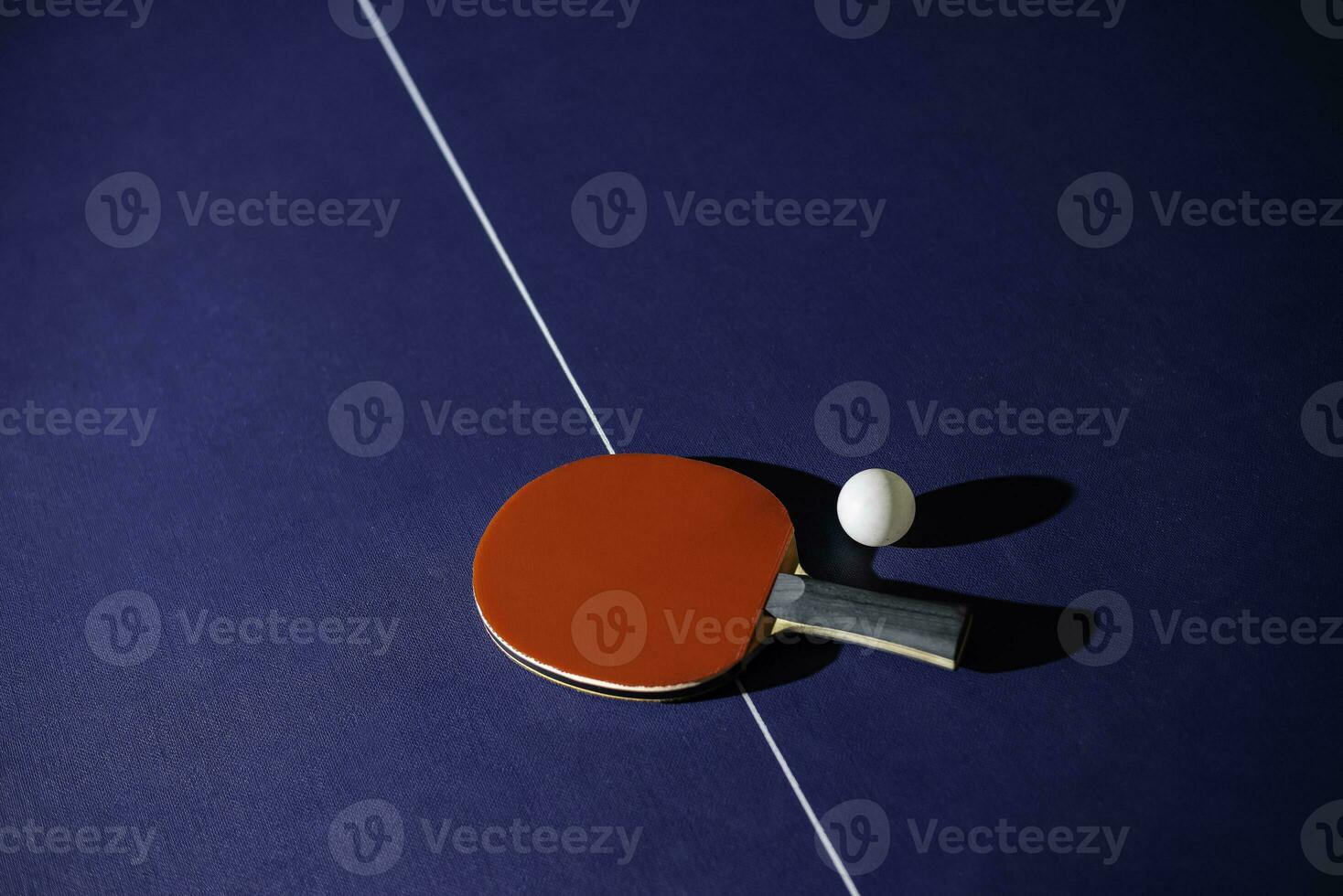 table tennis racket On the blue ping pong table photo