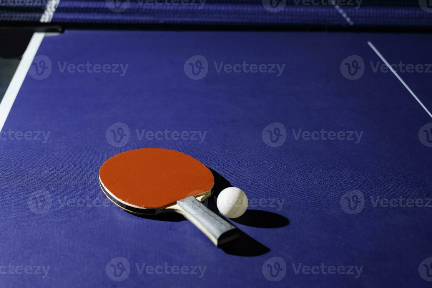 table tennis racket On the blue ping pong table photo