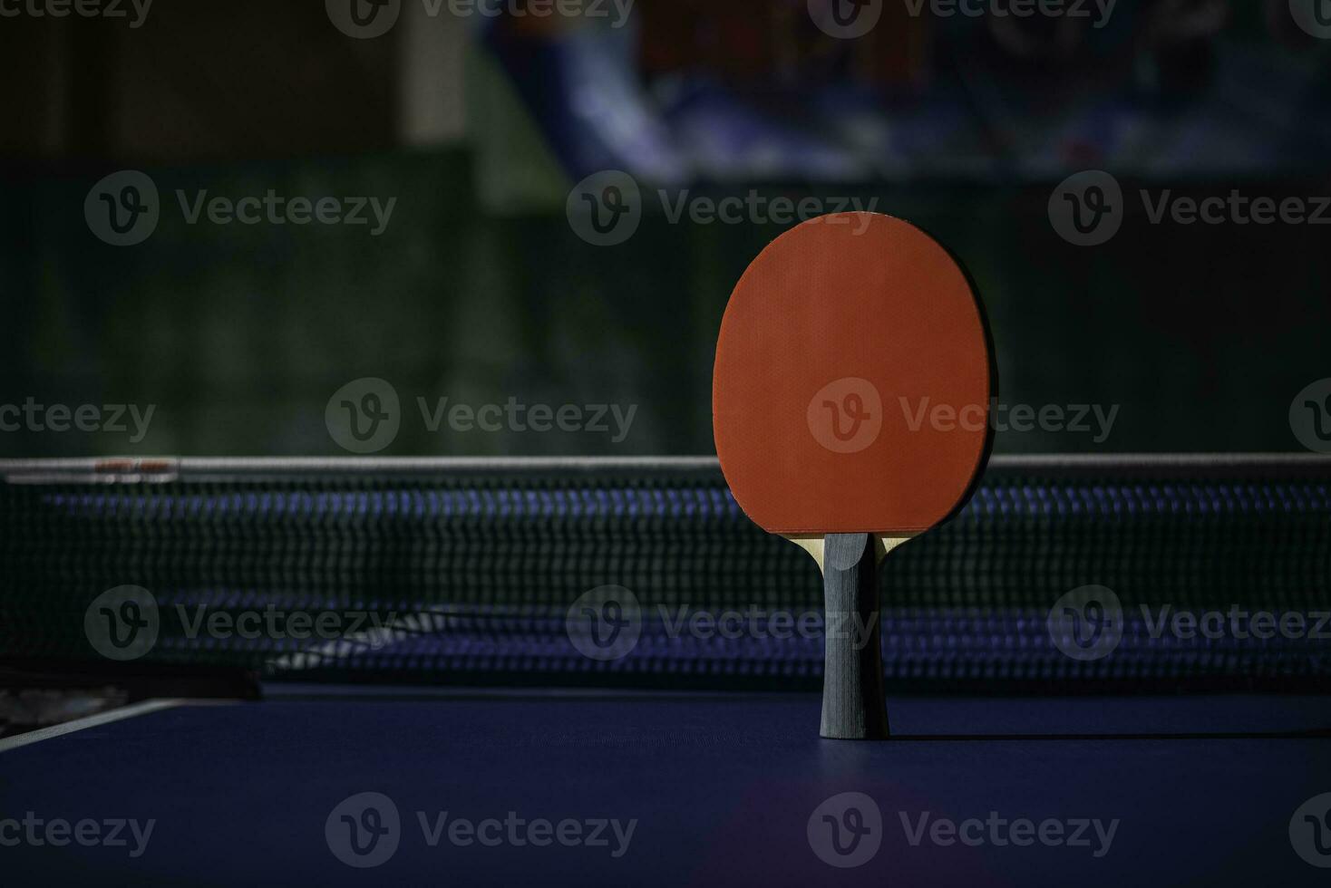 table tennis racket On the blue ping pong table photo
