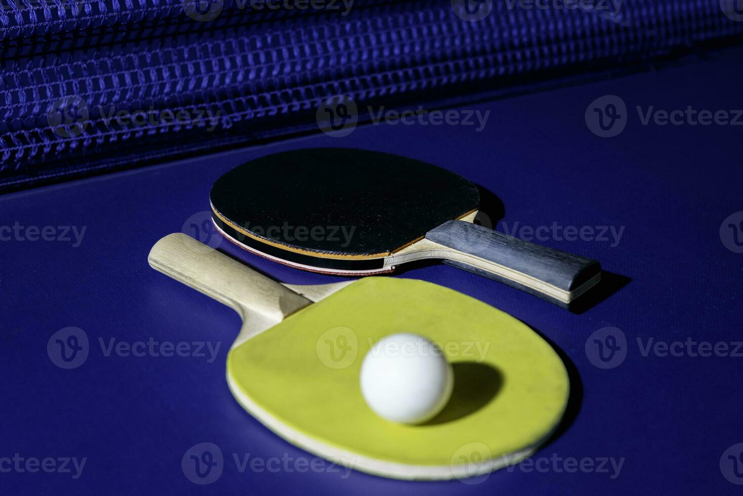 table tennis racket On the blue ping pong table photo