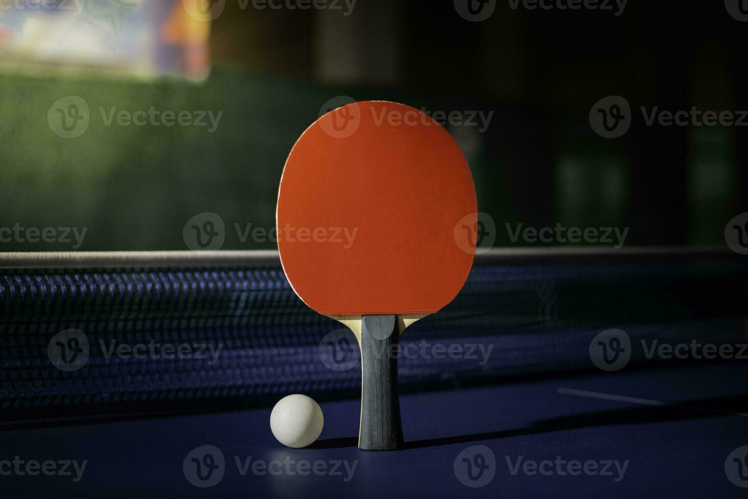 table tennis racket On the blue ping pong table photo