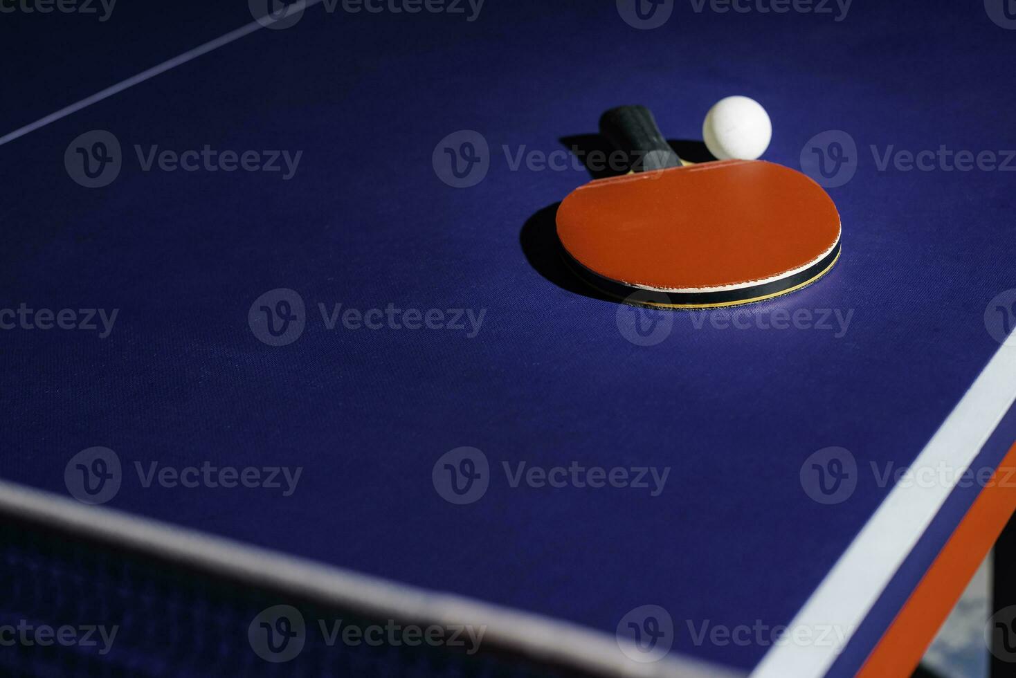 table tennis racket On the blue ping pong table photo