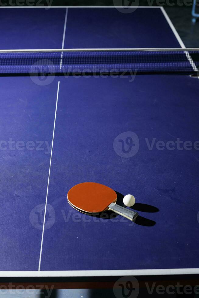 table tennis racket On the blue ping pong table photo