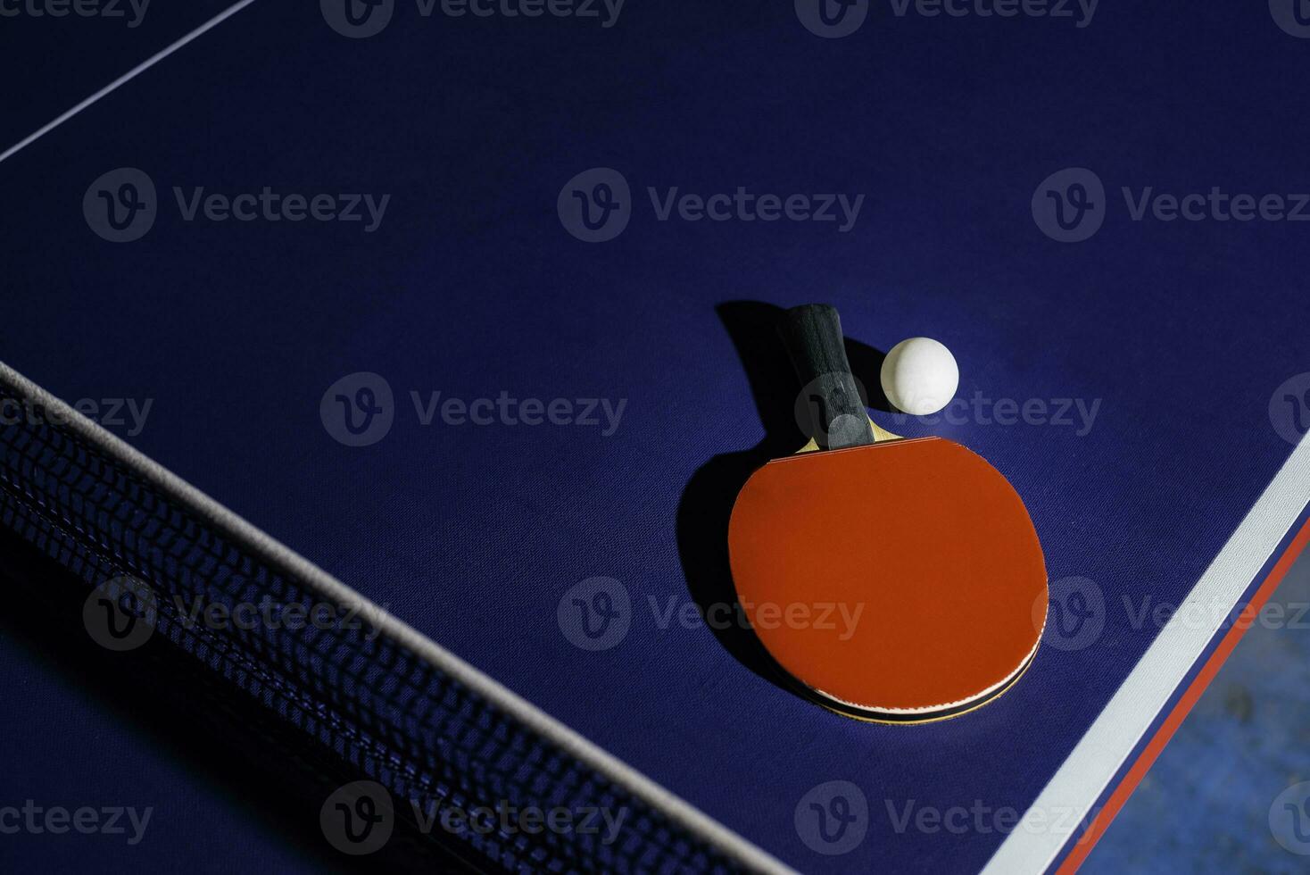 table tennis racket On the blue ping pong table photo