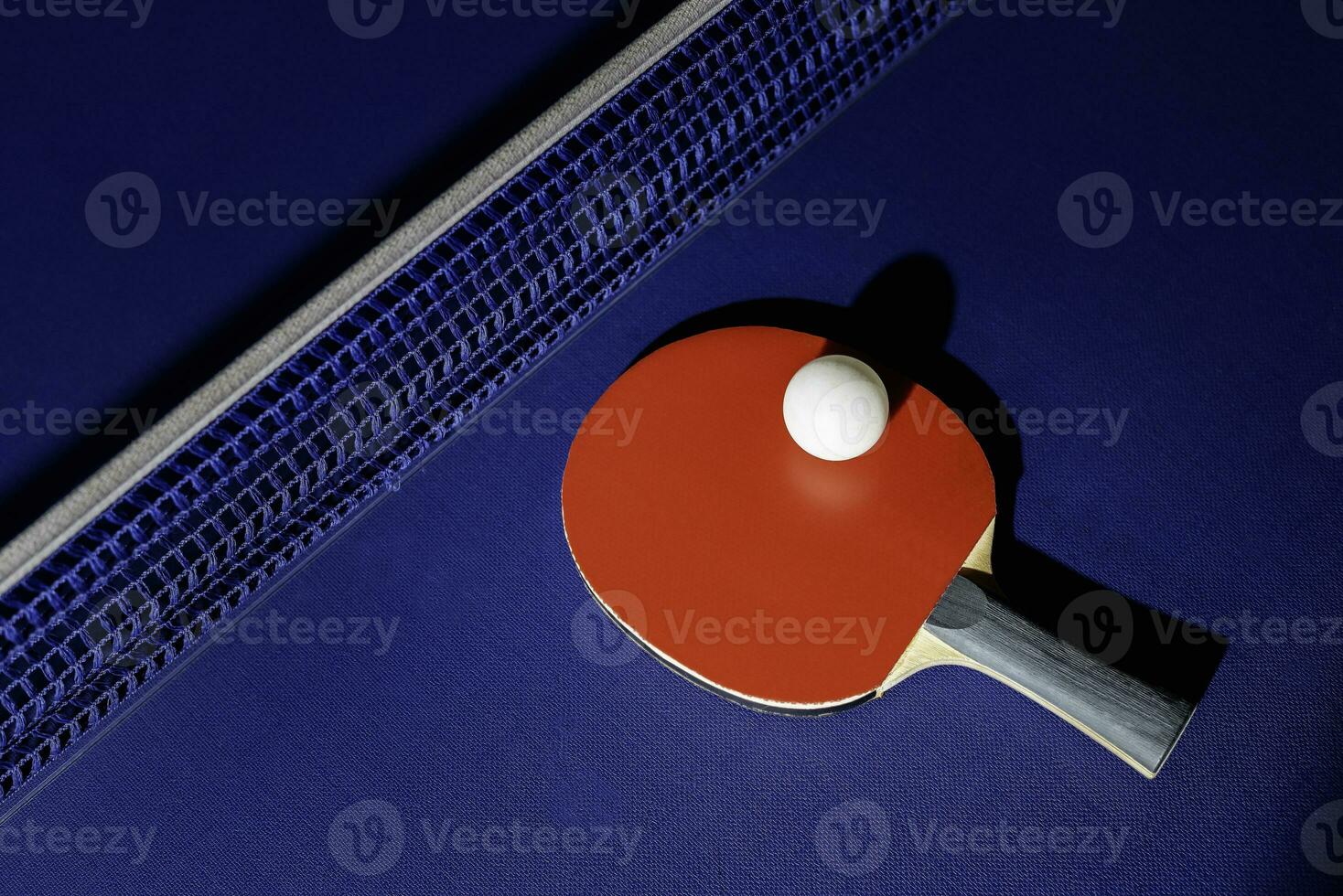 table tennis racket On the blue ping pong table photo