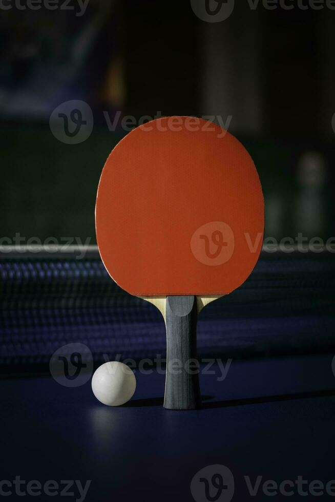 table tennis racket On the blue ping pong table photo