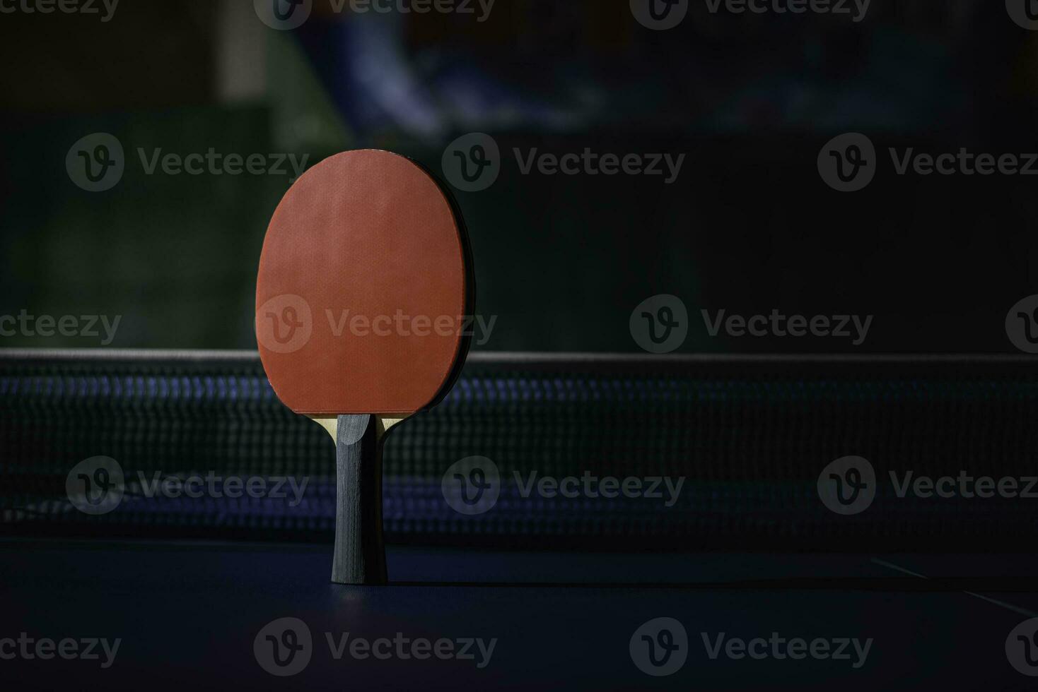 table tennis racket On the blue ping pong table photo