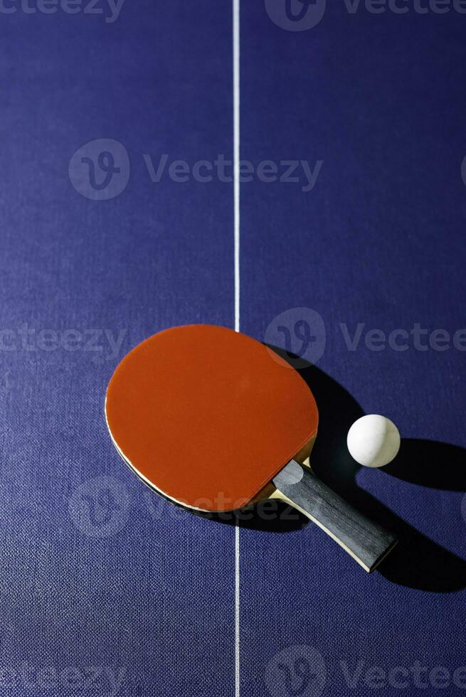 table tennis racket On the blue ping pong table photo