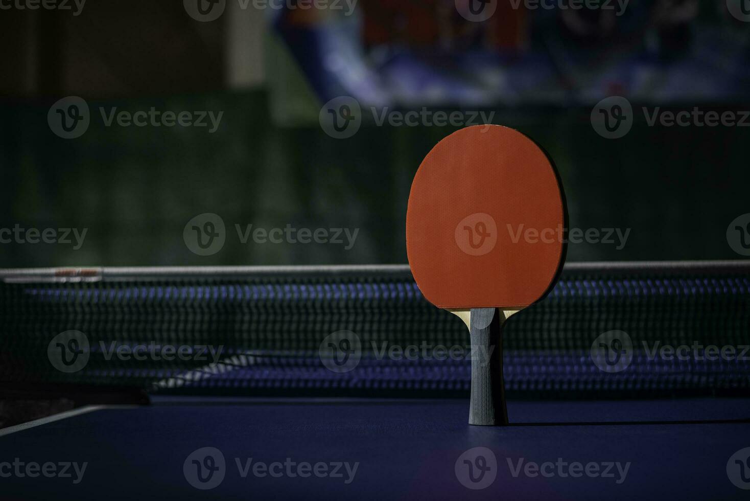 table tennis racket On the blue ping pong table photo