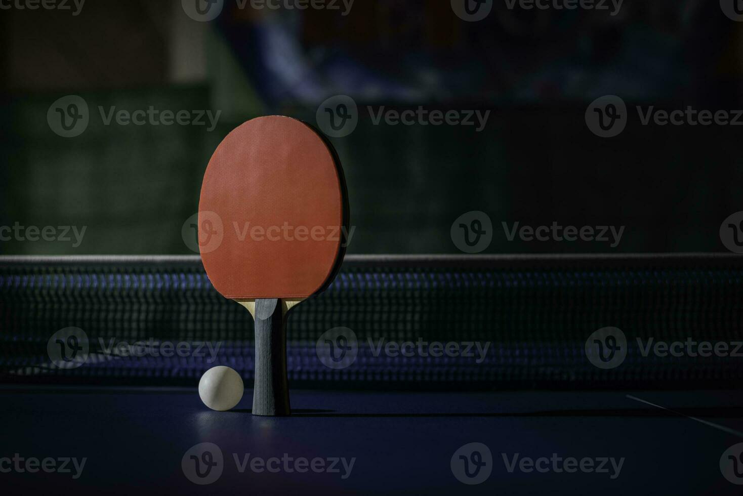 table tennis racket On the blue ping pong table photo
