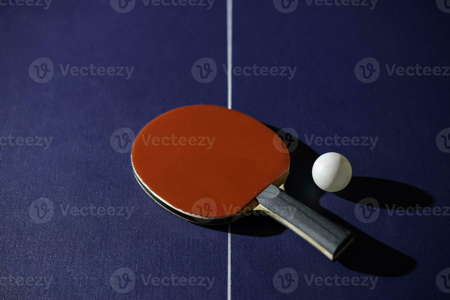 table tennis racket On the blue ping pong table photo