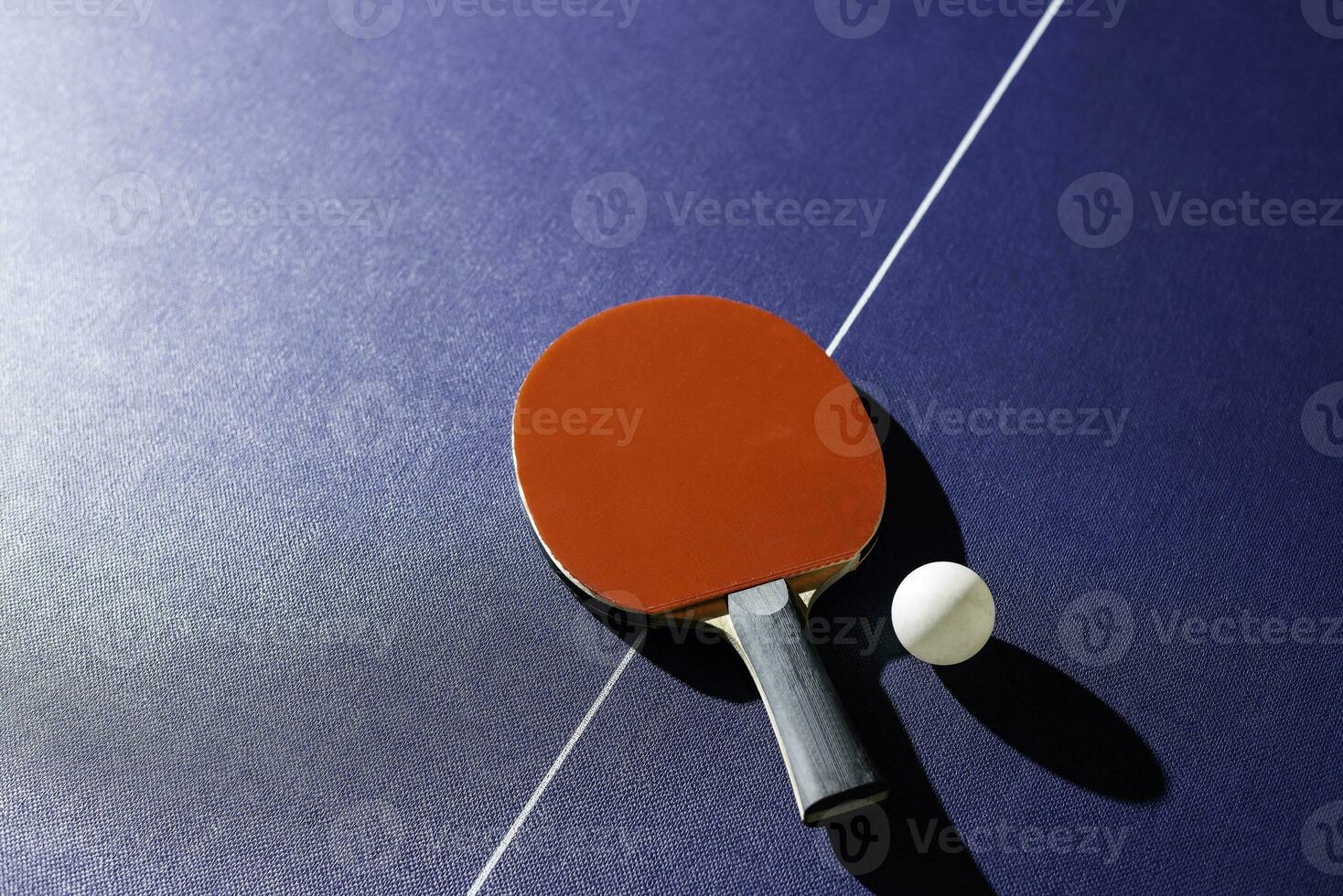 table tennis racket On the blue ping pong table photo
