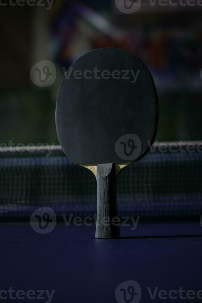 table tennis racket On the blue ping pong table photo