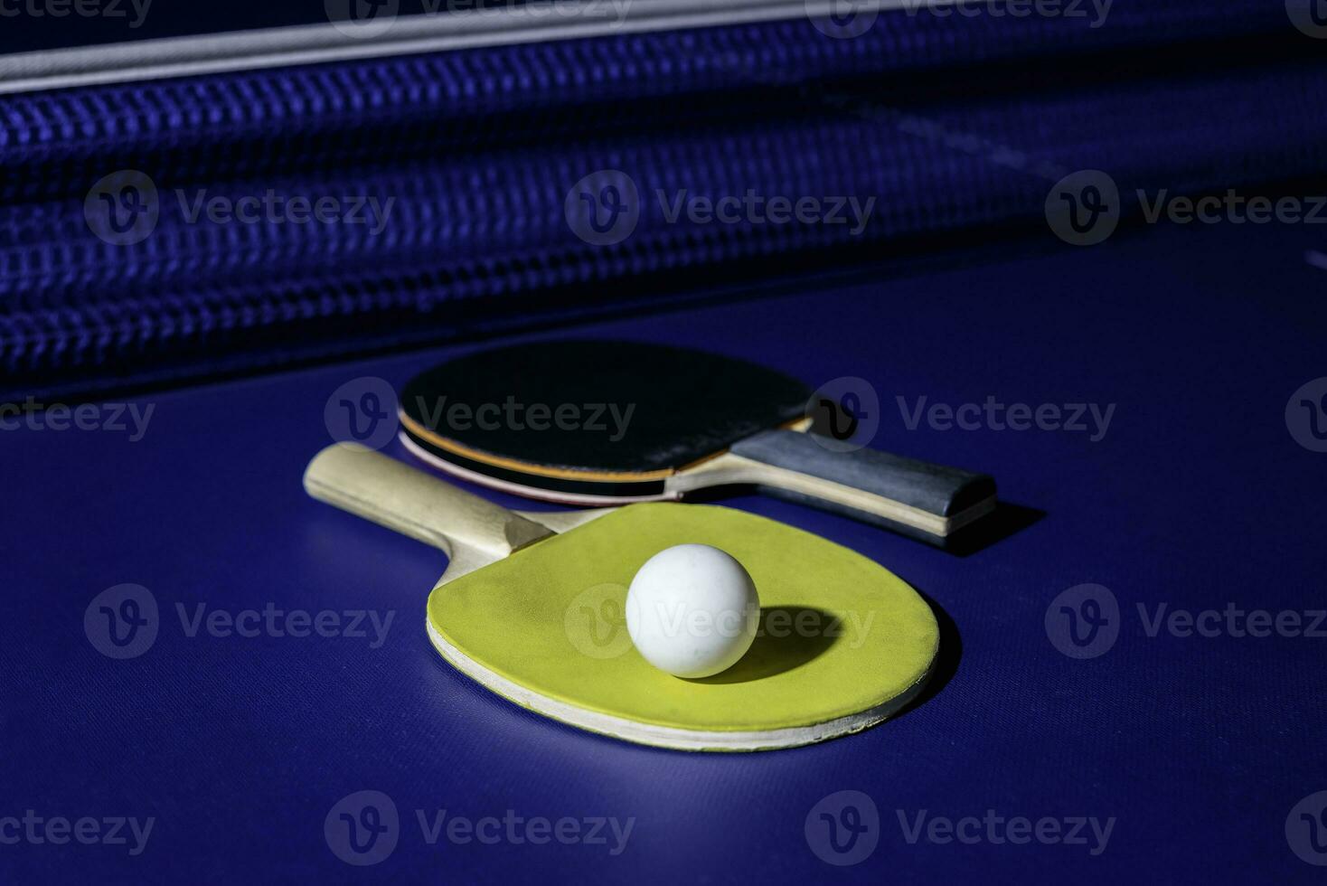 table tennis racket On the blue ping pong table photo