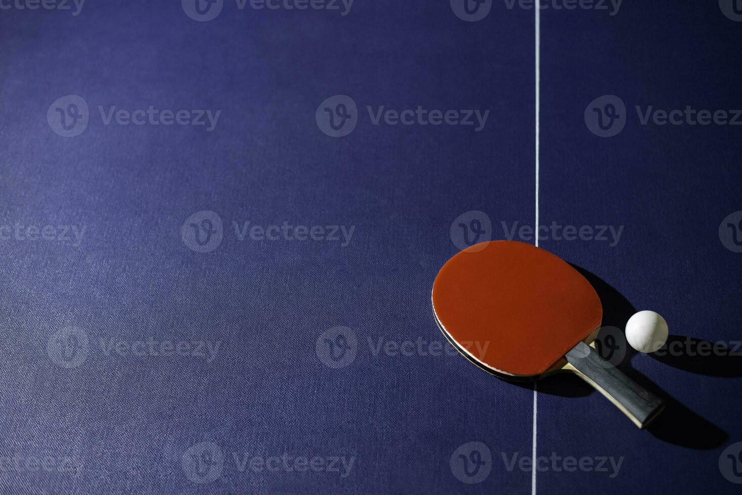 table tennis racket On the blue ping pong table photo