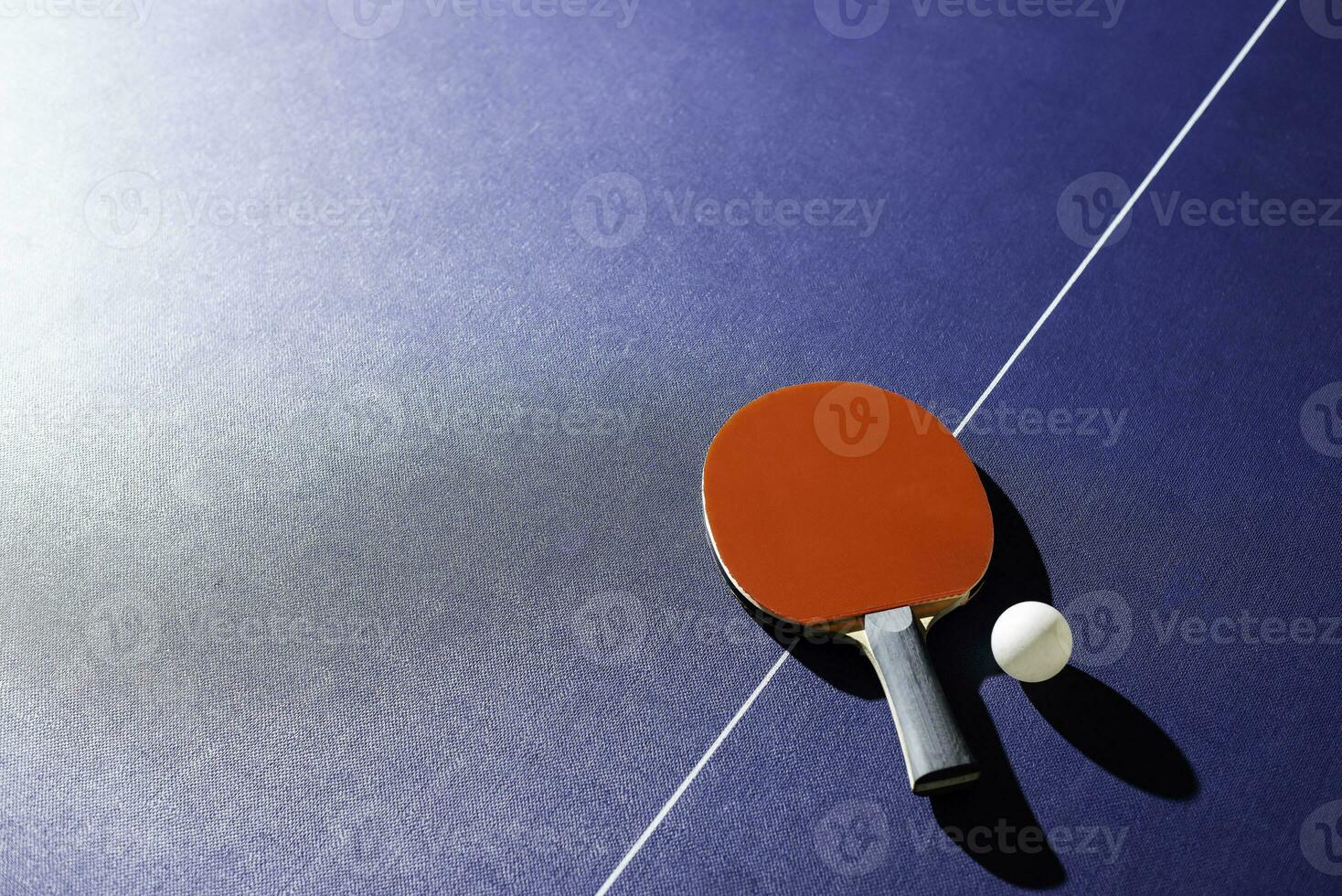 table tennis racket On the blue ping pong table photo