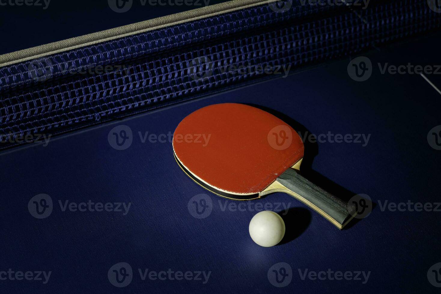 table tennis racket On the blue ping pong table photo