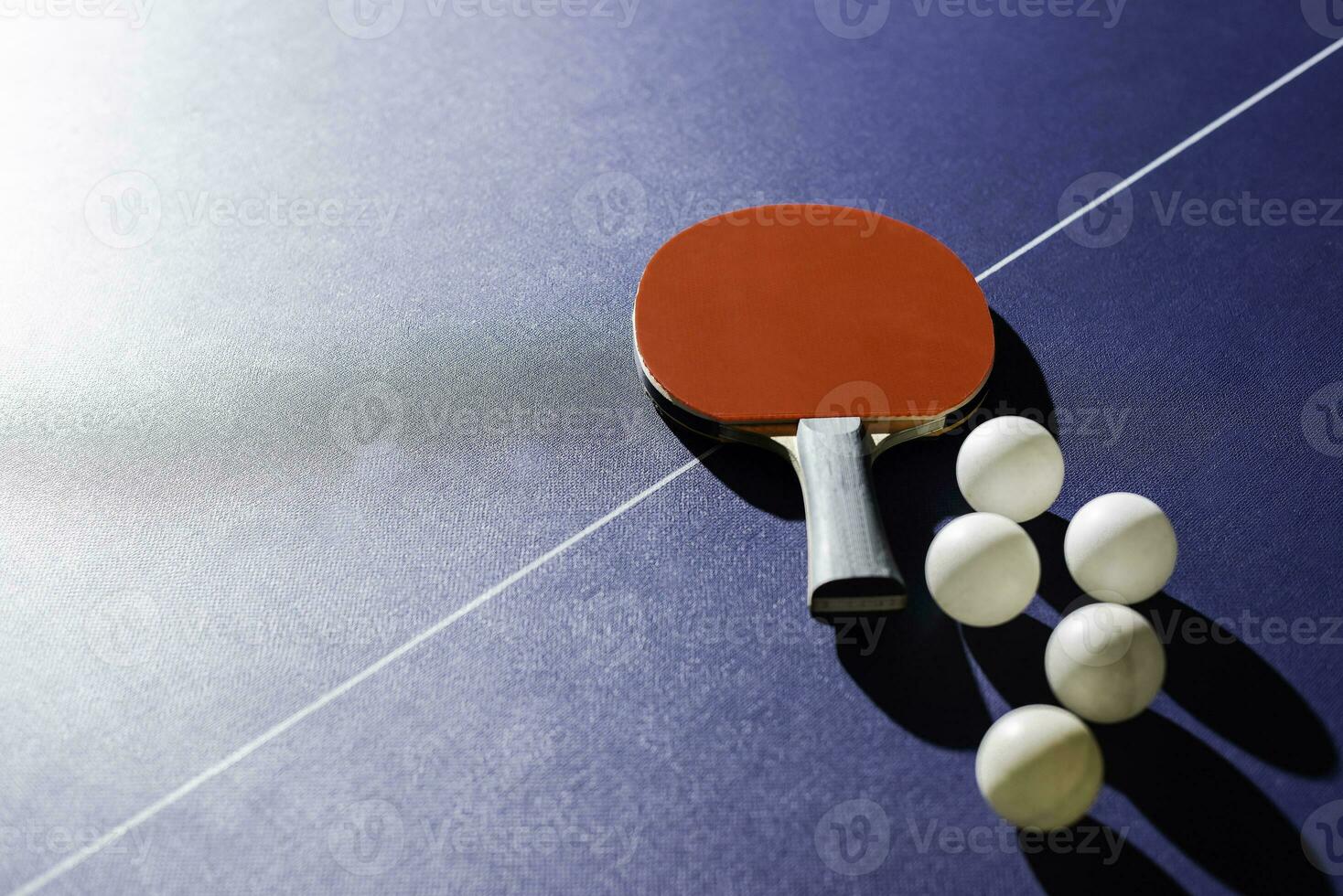 table tennis racket On the blue ping pong table photo