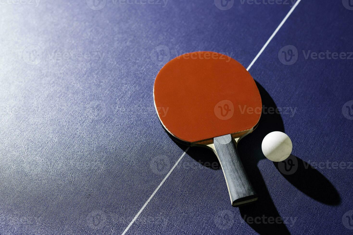 table tennis racket On the blue ping pong table photo