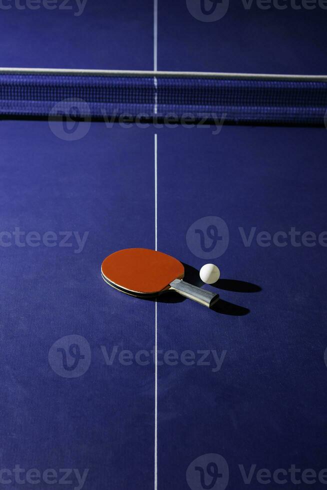 table tennis racket On the blue ping pong table photo